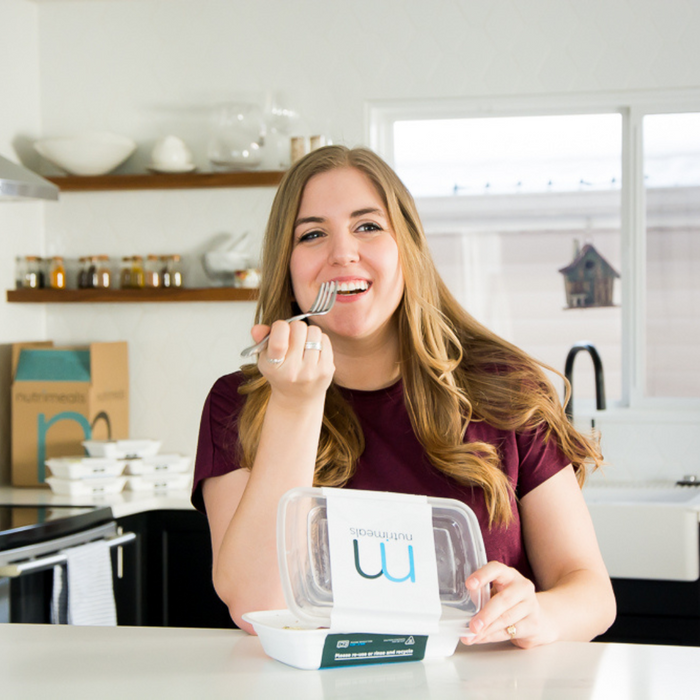 Girl smiling and eating a meal