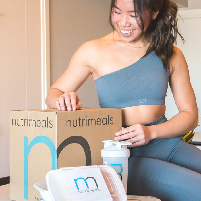 girl holding nutrimeals box