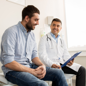 patient sitting on table with doctor reviewing doctors notes