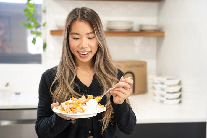girl holding plate of food