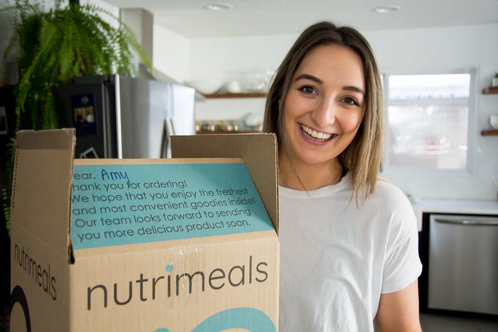 Girl smiling with box of food