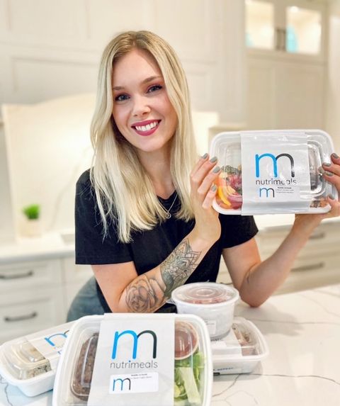 Girl holding a container of healthy meal prep