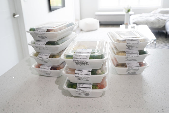 stack of healthy meal prep on white counter