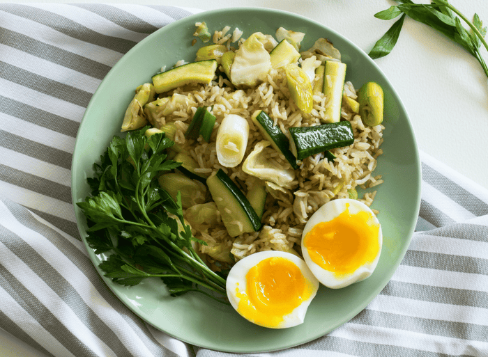 plate of food with whole grains, soft boiled egg and vegetables