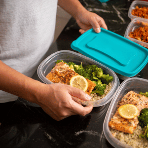 a man putting a lid on his container of food